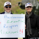 Protesters hold signs encouraging people to demand that businesses be allowed to open up, and people be allowed to work at the Country Club Plaza on April 20, 2020 in Kansas City, Missouri.